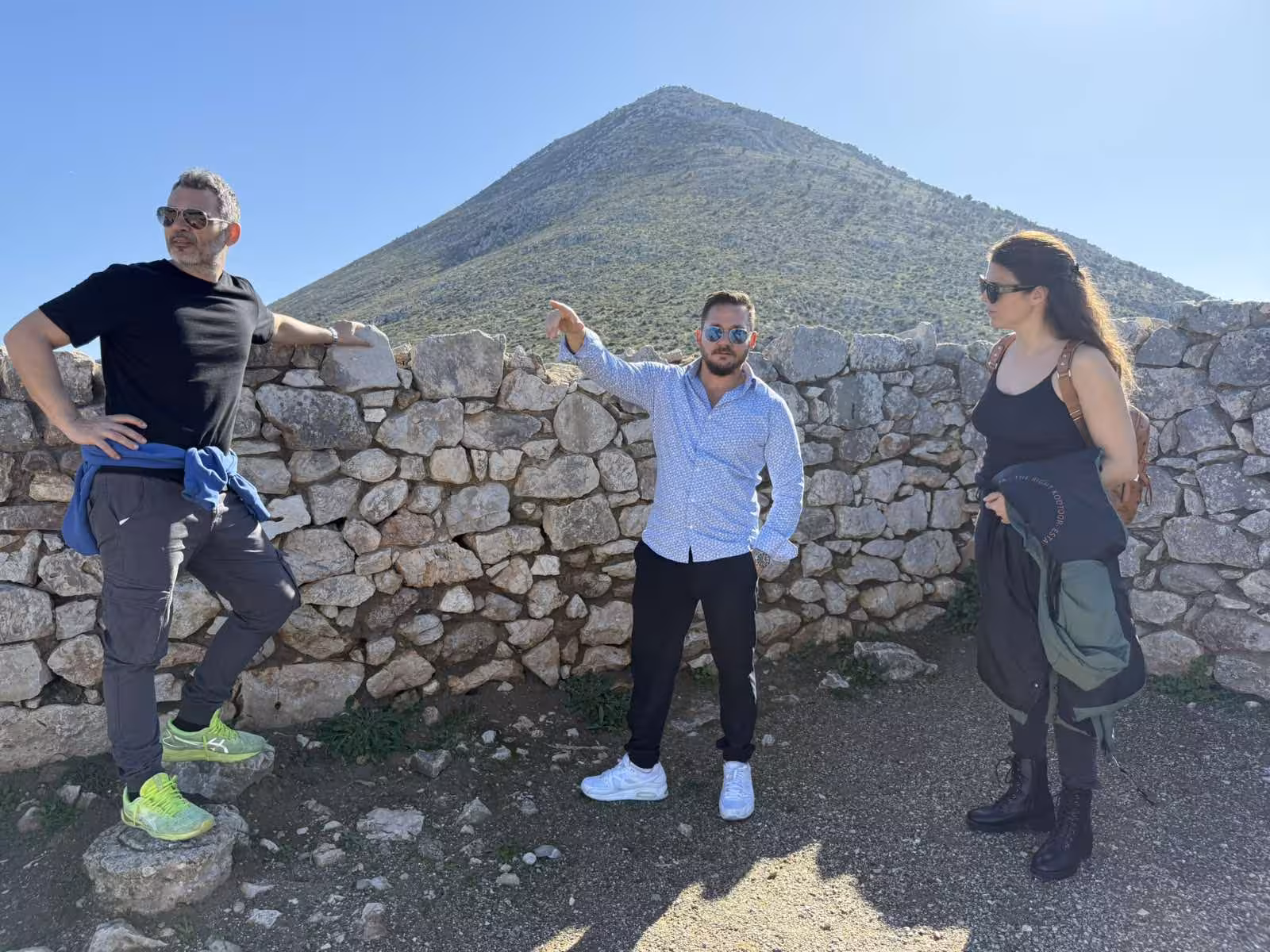 Private Mycenae tour guide briefing by Cyclopean walls with Mount Profitis Ilias, Peloponnese day trip