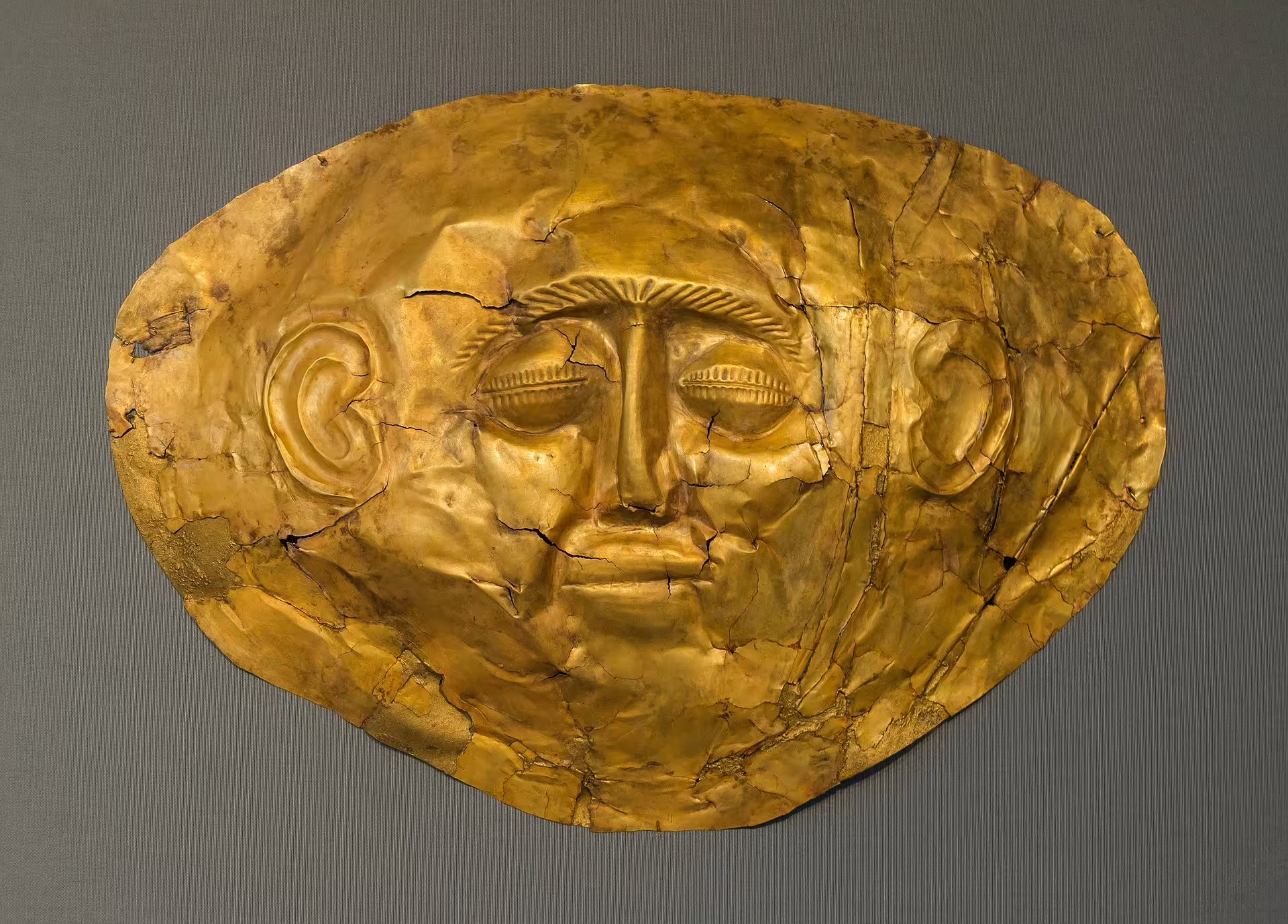 Gold Mycenaean funeral mask from Mycenae, featured on private Athens day trip to Nafplio and Epidaurus