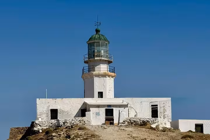 Mykonos Armenistis Lighthouse on a private island highlights tour, whitewashed landmark under blue sky