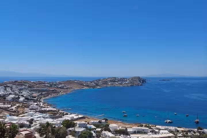 Panoramic Mykonos bay and whitewashed town from a scenic viewpoint on a customizable private island experience