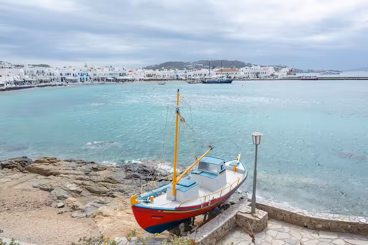 Traditional fishing boat by Mykonos Town waterfront, Aegean Sea views on a private Mykonos island highlights tour