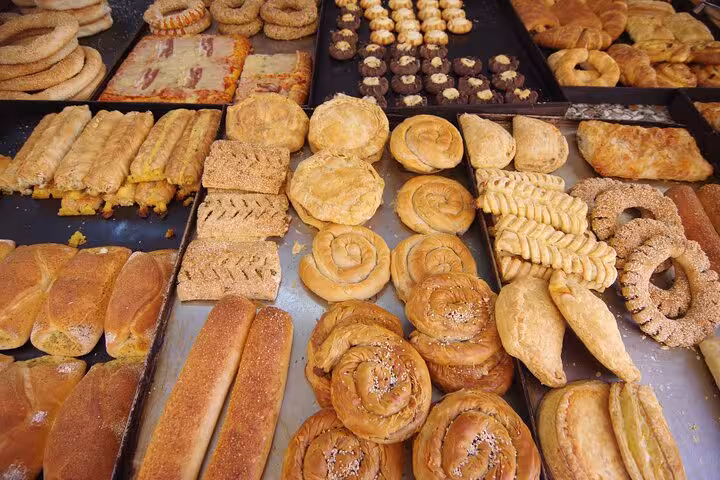 Traditional Mykonos bakery spread with Greek pastries and breads, tasty stop on the 5 Senses cruise tour