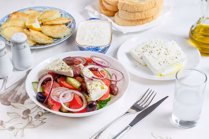 Greek salad with feta, olive oil and meze on a Mykonos food tasting, Explore Mykonos with your 5-Senses tour