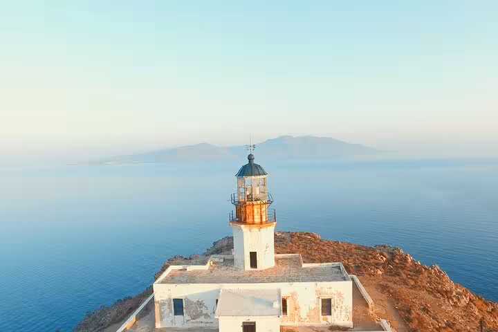 Lighthouse on rocky Mykonos coast above the Aegean Sea, hidden paradise stop on private half-day tour