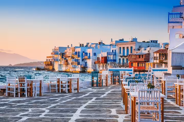 Outdoor dining by Little Venice in Mykonos at sunset, highlight of Mykonos Chora walking tour for cruisers