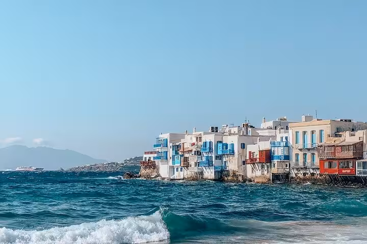 Waves below Little Venice waterfront houses in Mykonos Chora, highlight of a small group island tour walk