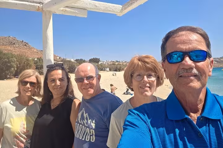 Small group enjoying a Mykonos beach stop during a private, customizable island experience with local guide