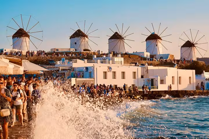 Mykonos Little Venice windmills at sunset with waves and crowds, a private custom experience and photo stop