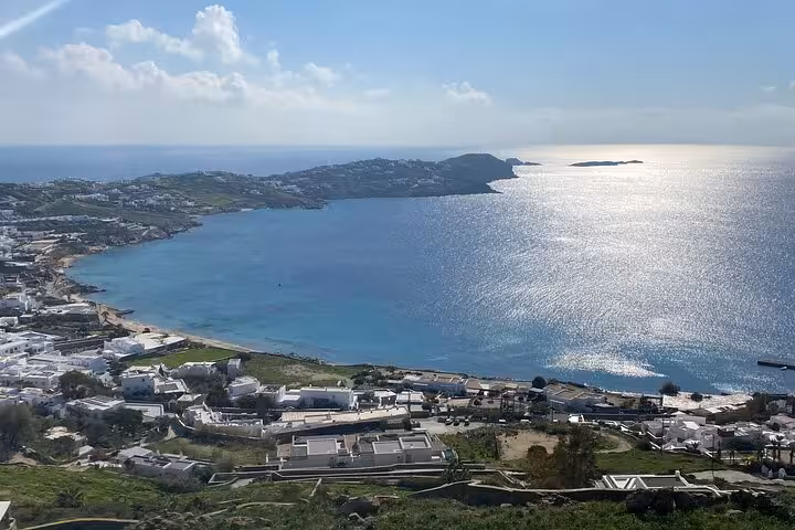 Panoramic Mykonos coastline and sparkling Aegean Sea view during a private half-day island sightseeing tour