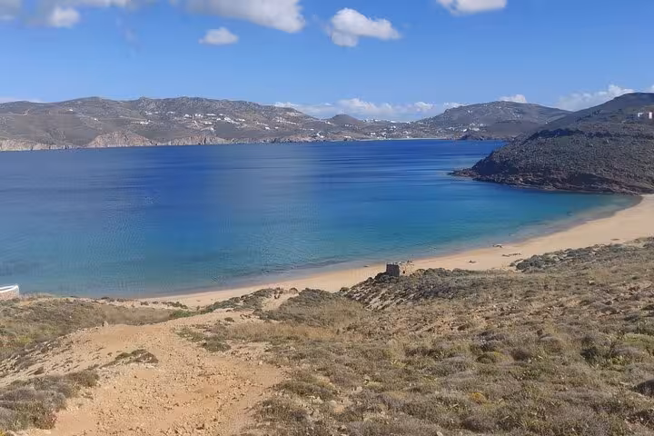 Secluded turquoise bay and sandy beach on Mykonos, stop on a half-day private island tour to hidden paradise