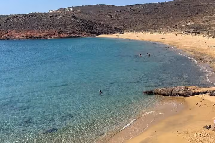 Crystal-clear turquoise bay and sandy beach stop on a Mykonos private island half-day tour in the Aegean