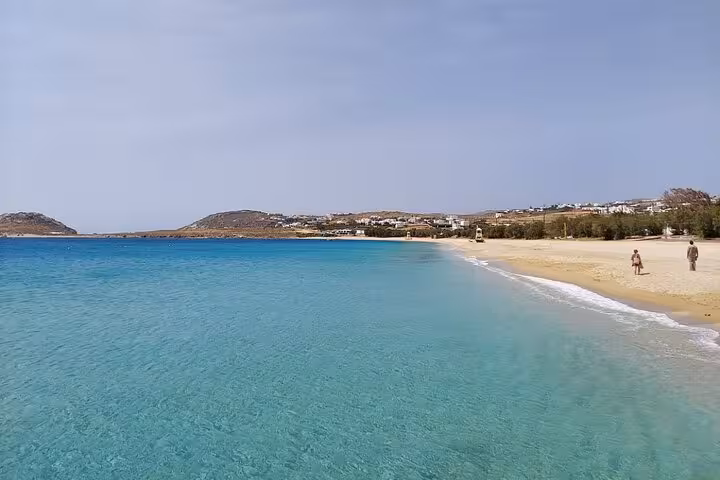 Turquoise beach and sandy shoreline on Mykonos private half-day island tour with Aegean Sea views
