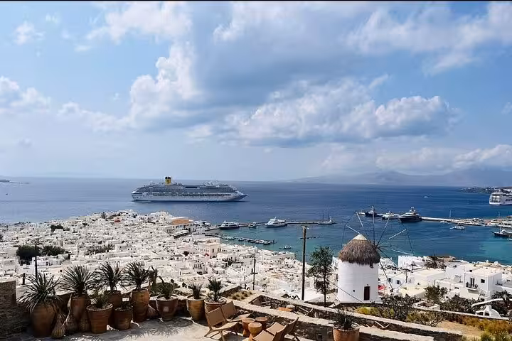 Scenic Mykonos town and Aegean Sea view with windmill and cruise ship, Mykonos private highlights tour