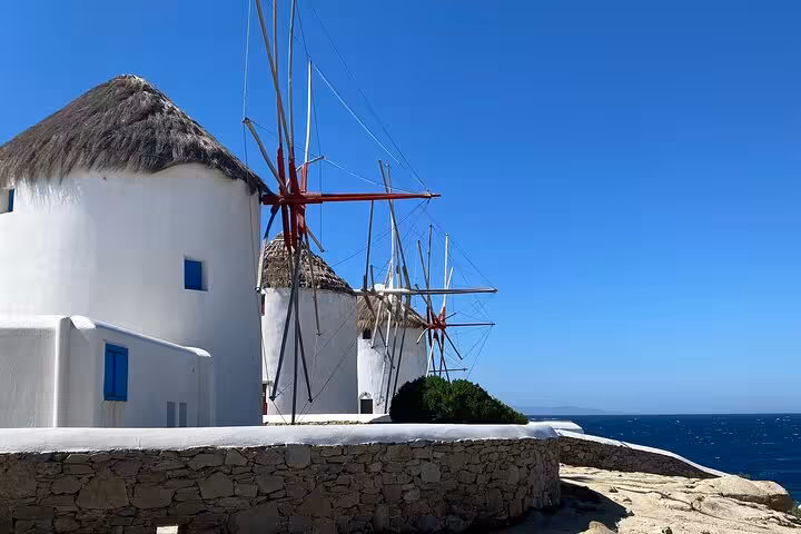 Mykonos Town windmills by the sea under blue sky, highlight stop on a private walking tour in Greece