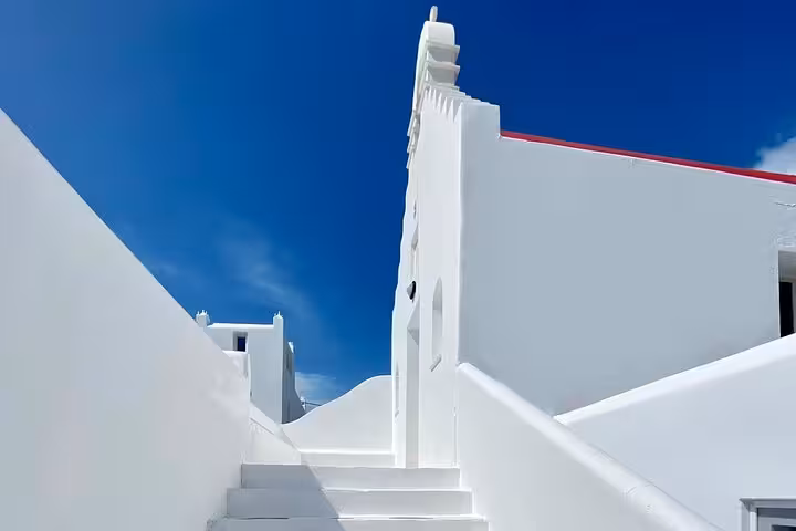 Whitewashed Mykonos alley and steps in Chora, Cycladic architecture on a private half-day island tour