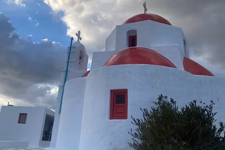 Whitewashed Mykonos church with red dome and crosses, iconic Cycladic stop on private highlights tour