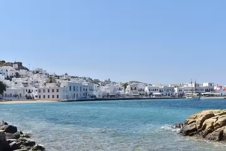 Mykonos waterfront with whitewashed houses and turquoise bay, scenic island views near hidden beaches and villages