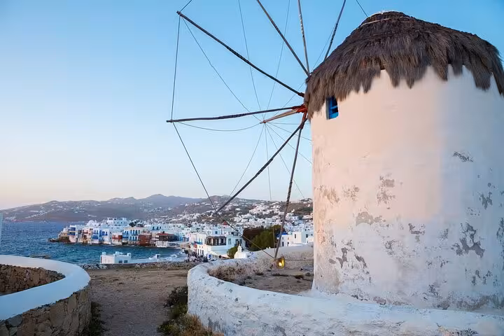 Mykonos windmill overlooking Little Venice and the Aegean Sea, iconic view on the From Athens day tour