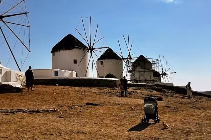 Traditional Mykonos windmills in Chora under blue sky, must-see stop on a private half-day island tour