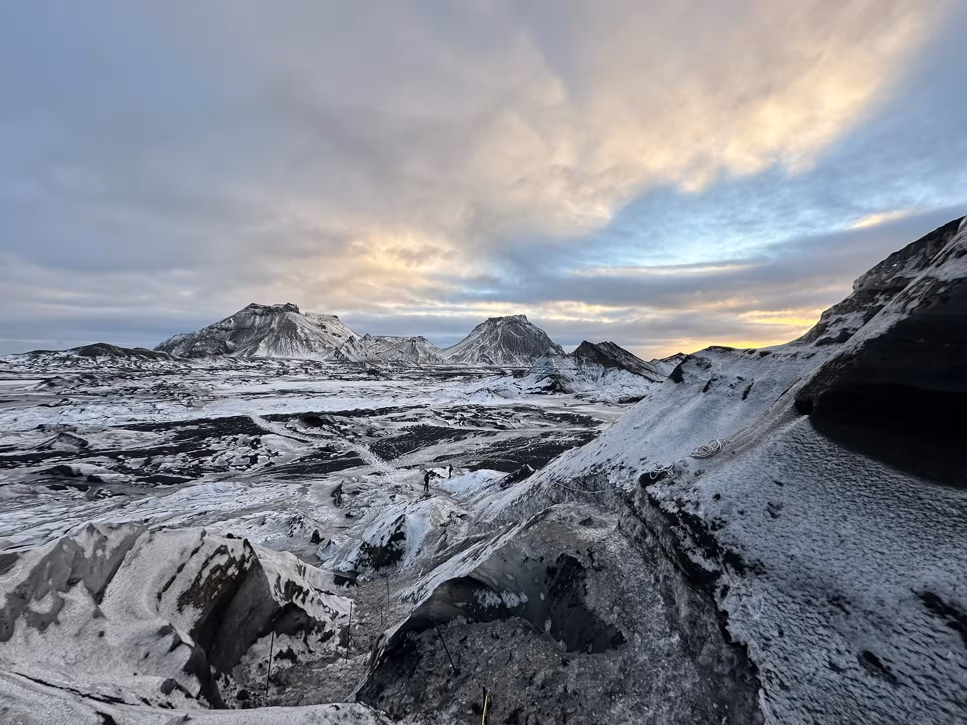 Expansive snow-dusted Myrdalsjokull glacier landscape with volcanic peaks at sunset on Katla ice cave day trip from Vik