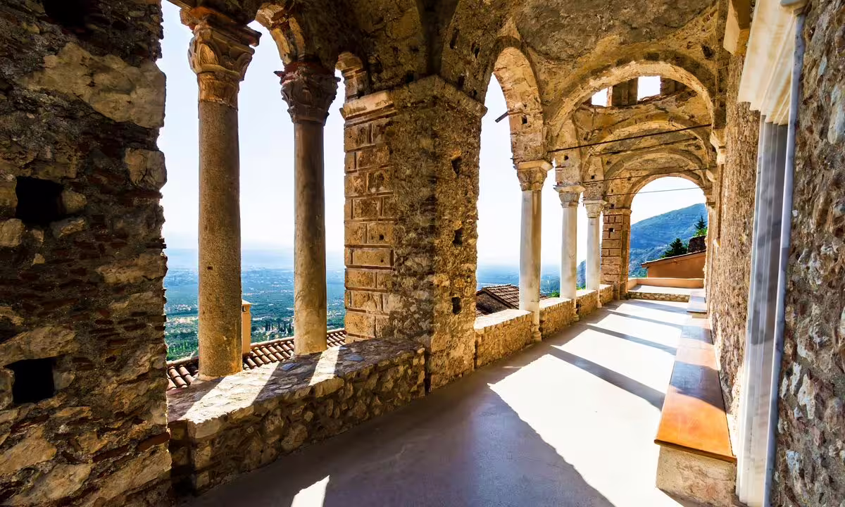 Arched cloister corridor in Mystras Byzantine monastery with valley views on 2-day private Sparta Mystras Monemvasia tour