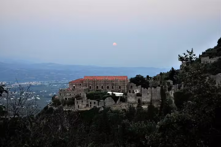 Twilight view of Mystras fortress ruins above the Sparta valley, scenic moment on a 2-day Peloponnese tour