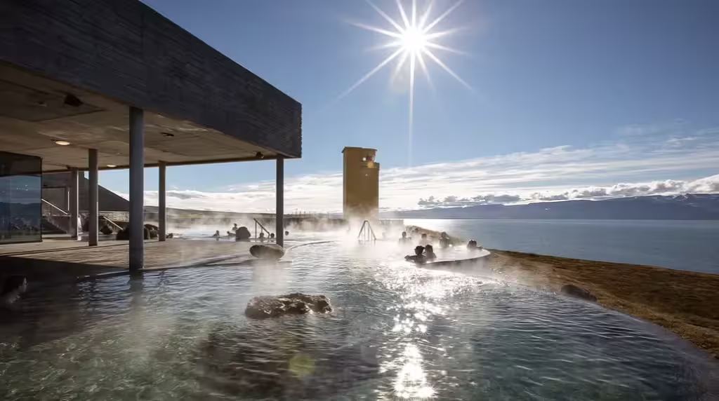 Steaming geothermal hot spring pool at Myvatn Nature Baths with lake and mountain views, Akureyri Iceland