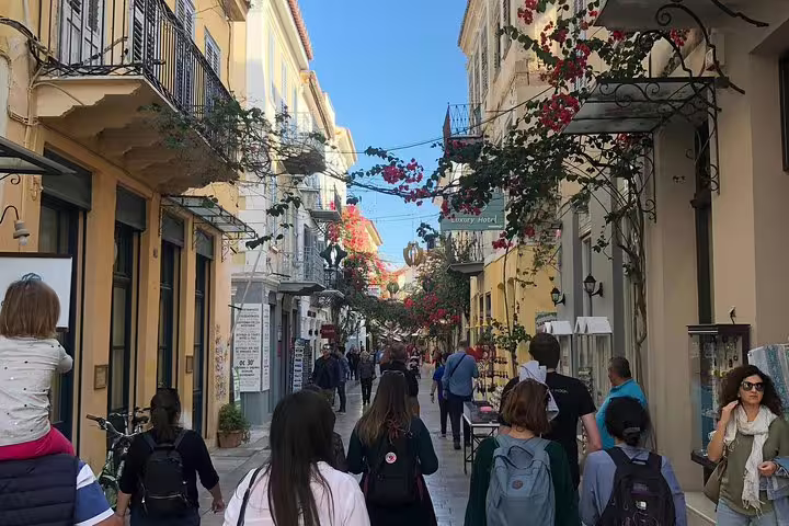 Nafplio old town street with balconies and bougainvillea, scenic stop on a private Athens to Peloponnese day trip