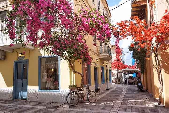 Charming Nafplio old town street with bougainvillea and bicycle, on a private day trip from Athens Greece