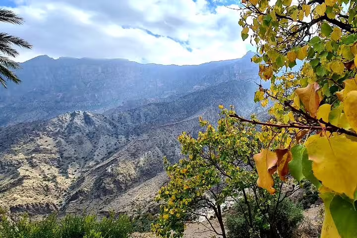 Breathtaking mountain landscape with vibrant foliage in Wakan Village, ideal for a Nakhal Hotspring excursion.