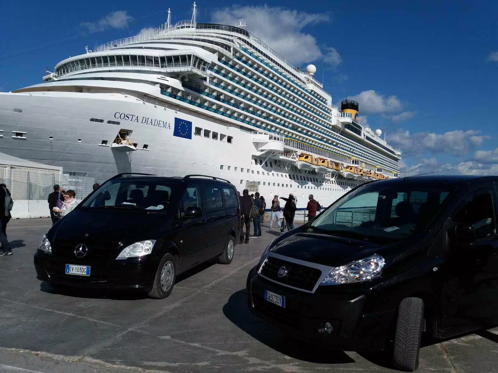 Black minivans waiting at Naples cruise port near Costa Diadema ship for private transfer service to Benevento and return