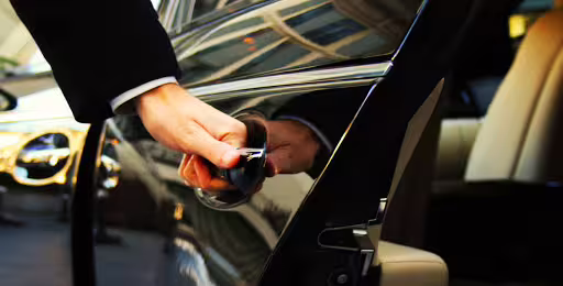 Driver hand opening car door for Naples to Caserta private transfer, reliable chauffeur service and pickup