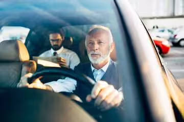 Professional chauffeur driving executive car for private transfer service between Naples and Caserta, Italy