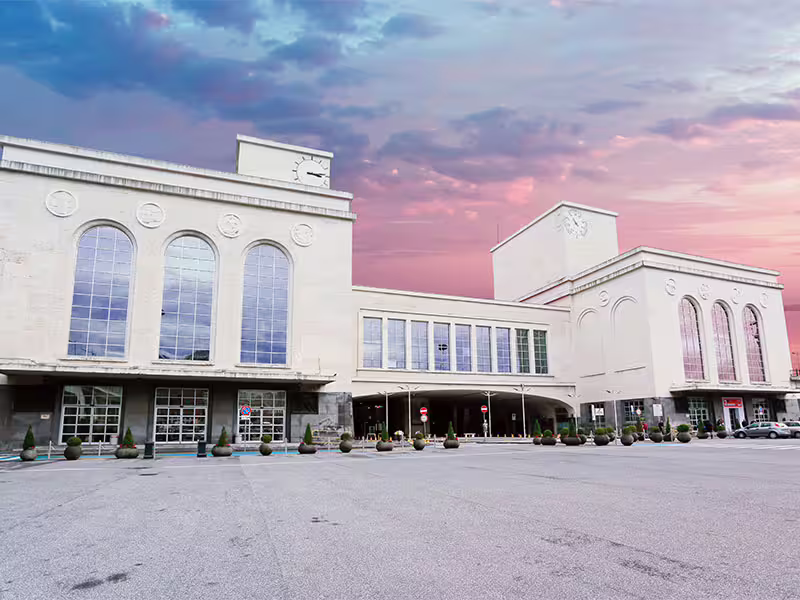 Naples Centrale train station facade at sunset, meeting point for private transfer Naples to Caserta