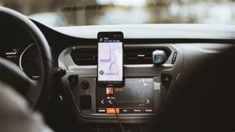GPS navigation on smartphone mounted in modern vehicle, guiding private transfer route between Naples and Paestum Italy