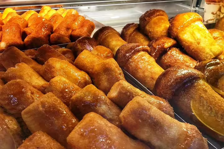 Golden fried Neapolitan street food snacks displayed at a Naples food market stall during a city walking tour