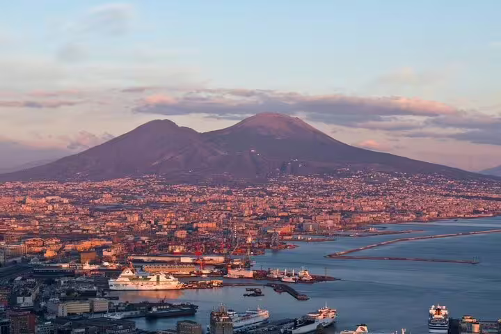 Panoramic Naples waterfront with Mount Vesuvius at sunset, scenic view on private Pompeii tour from Naples