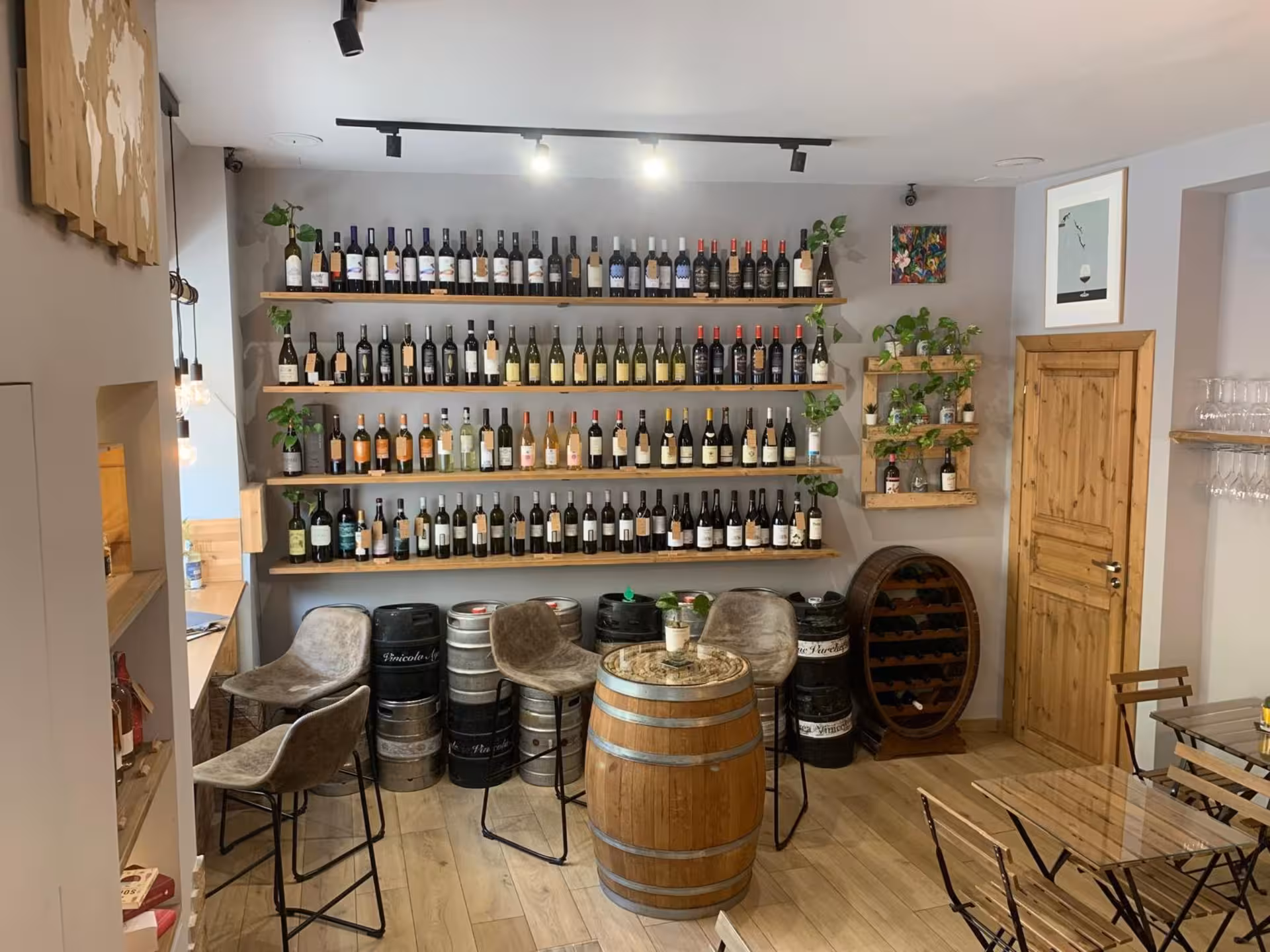 Cozy wine bar interior in Naples featuring rustic decor and an extensive wine selection on shelves.