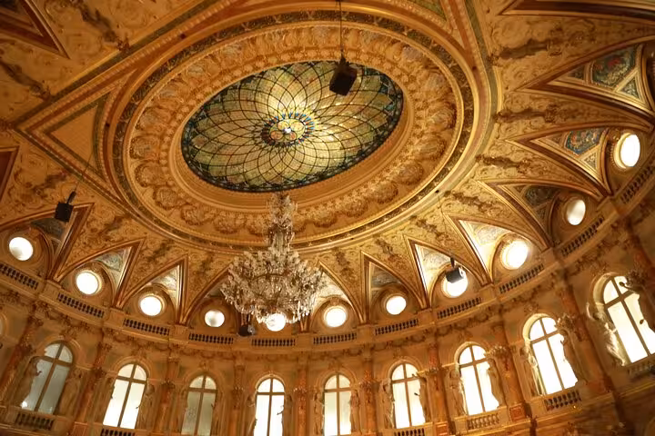Opulent Napoleon III Paris interior with stained-glass dome and crystal chandelier on Haussmann tour