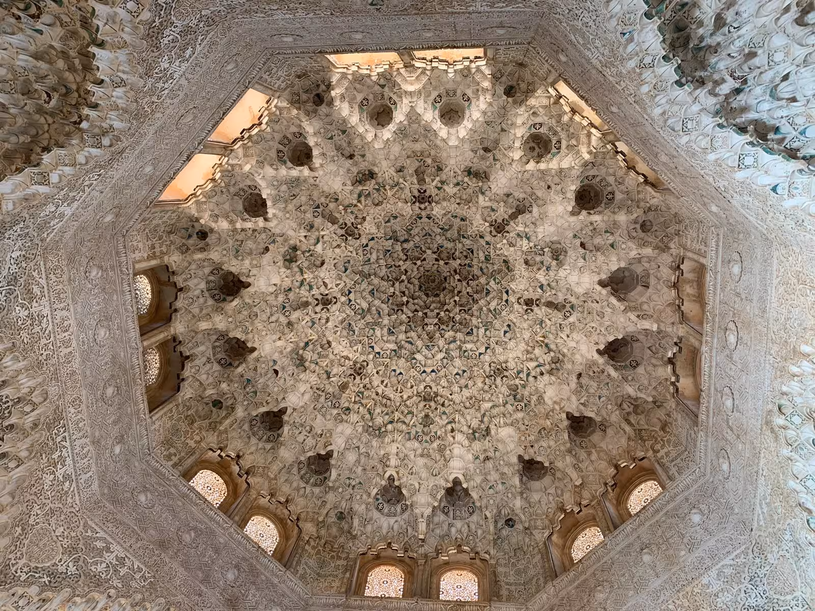 Intricate ceiling of the Nasrid Palaces in the Alhambra, featuring elaborate Moorish designs and patterns.