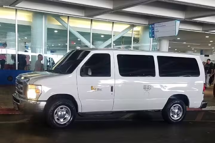 White private transfer van at Nassau Cruise Port ready for comfortable hotel transfers in Nassau Bahamas