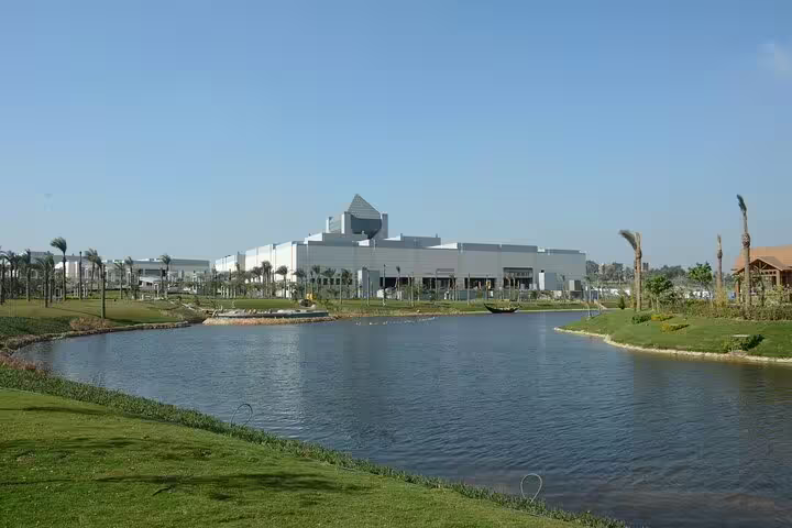 Exterior view of the National Museum of Egyptian Civilization beside a lake on a guided tour from El Sokhna port