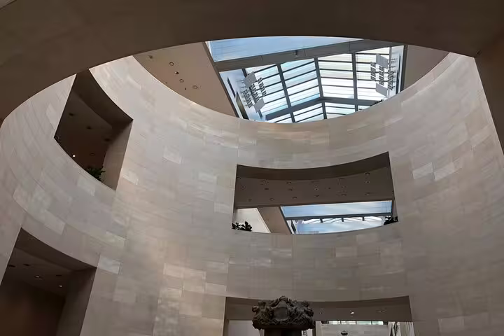 Curved white stone walls and skylight atrium inside the National Museum of Korea in Seoul