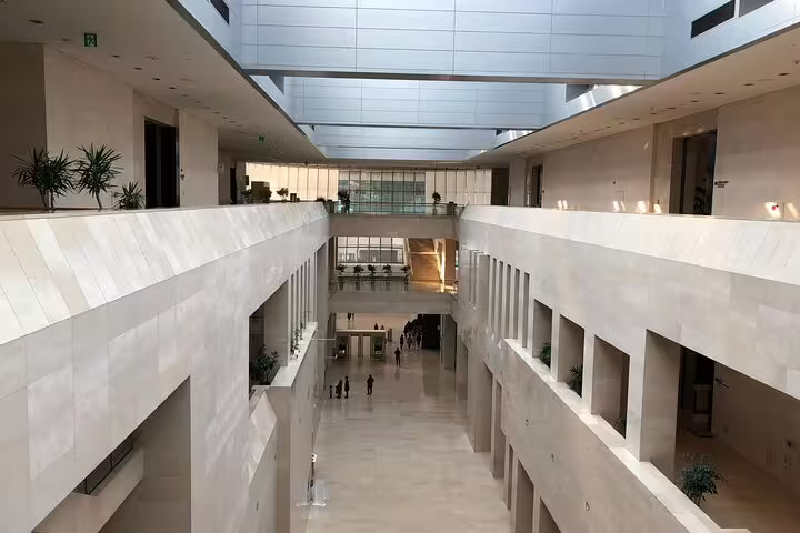 Multi-story atrium interior of the National Museum of Korea with white marble walls and open galleries