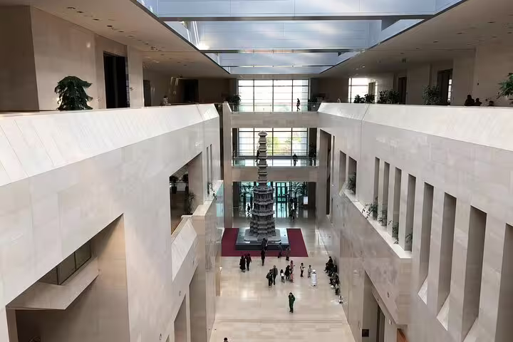 Grand atrium of National Museum of Korea in Seoul with multi-story pagoda centerpiece and visitors