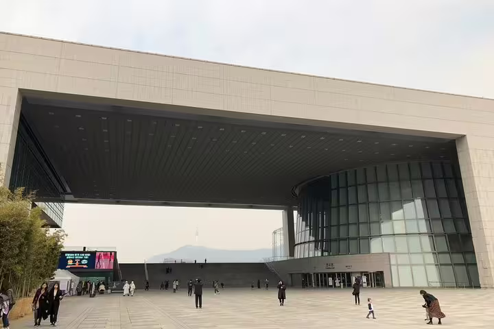 Exterior entrance of the National Museum of Korea in Seoul with visitors walking on plaza