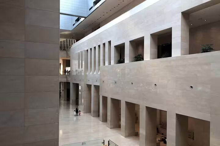 Grand marble atrium interior of the National Museum of Korea with multi-level arcaded walls in Seoul