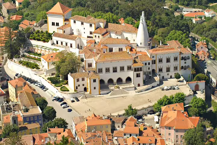 Aerial view of the National Palace of Sintra, showcasing its iconic chimneys and historic architecture during a private full-day tour.