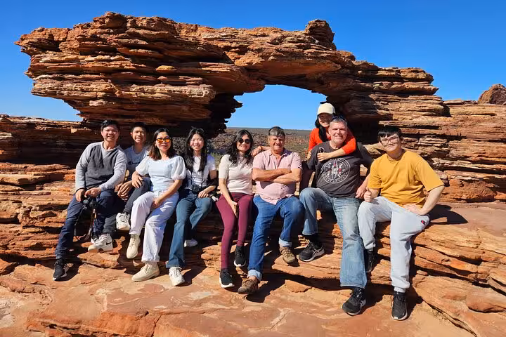 Group enjoying the breathtaking view at Nature's Window, a natural rock arch in Kalbarri National Park.