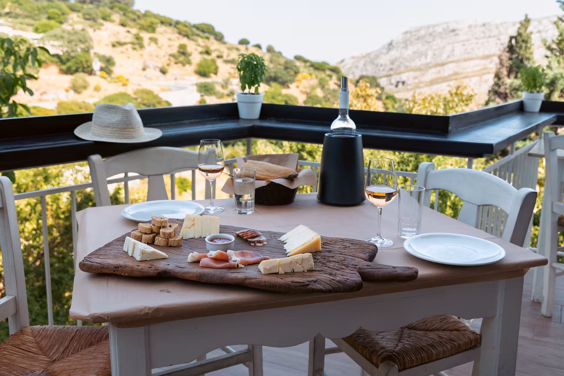Naxos village food tour tasting board with local cheeses, cured meats and wine on a scenic terrace